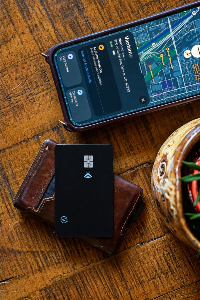 iPhone showing a stylized map location beside a wallet holding the tracker card