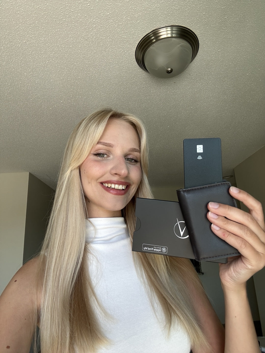 Customer smiling while unboxing her Vantamo tracker card